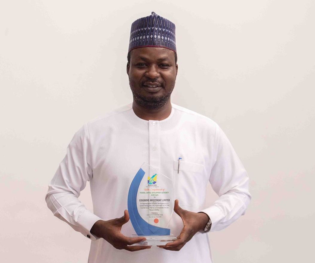 Chairman, Cosgrove Investment Limited, Mr Umar Abdullahi poses with the plaque of appreciation bestowed by FCDA